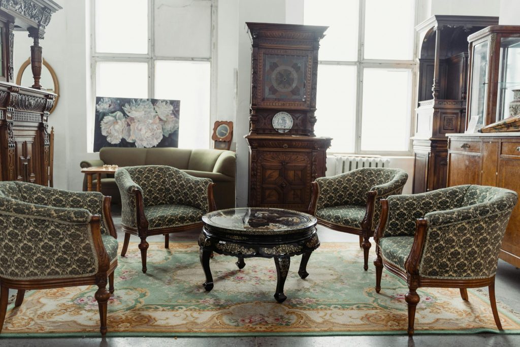 Vintage living room with antique wooden furniture and classic upholstered chairs